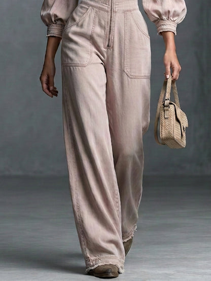 This Washed, Distressed Denim Jumpsuit In A Nude-pink Hue Features A Collared Deep V-neck Off-the-shoulder Design Puff Sleeves And A Front Zipper